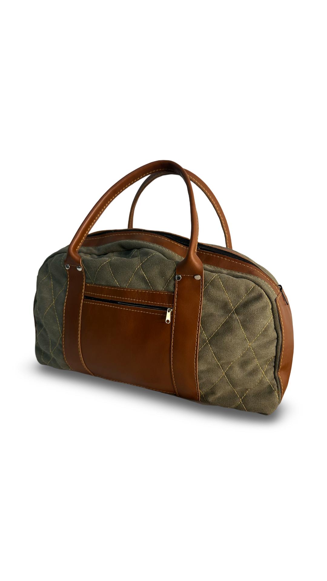 An olive green canvas weekend overnight bag with brown leather accents and a quilted design. Cape Town Handcrafted Artisan